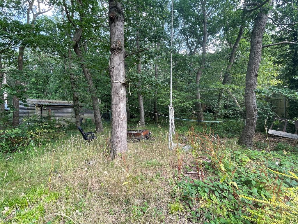 Lot: 82 - DETACHED BUNGALOW WITH POTENTIAL FOR REDEVELOPMENT - Wooded garden to rear